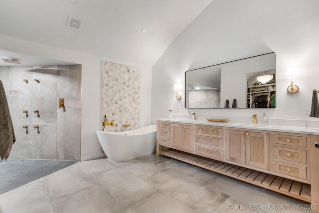 bathroom with a sink, vaulted ceiling, a soaking tub, double vanity, and walk in shower