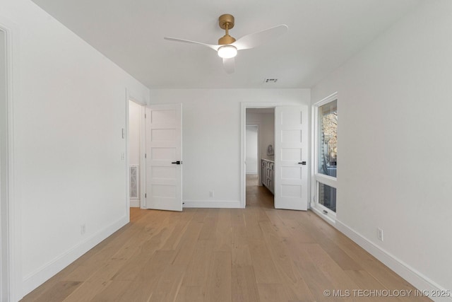 unfurnished bedroom featuring visible vents, a ceiling fan, light wood-style flooring, and baseboards