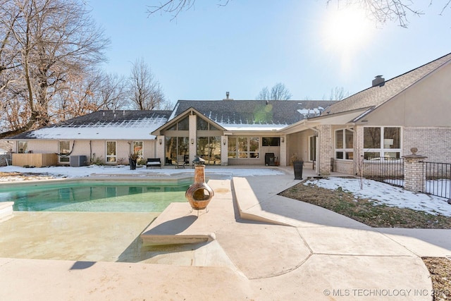 view of swimming pool with central air condition unit, fence, a fenced in pool, and a patio