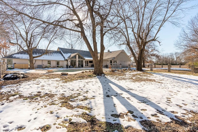 view of front of home featuring fence and a chimney