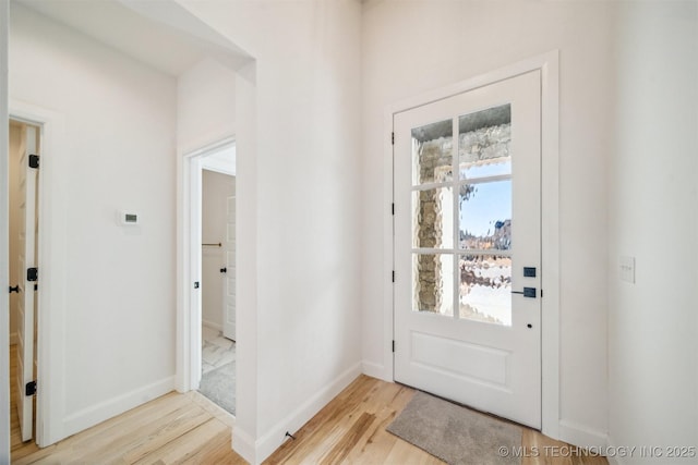 doorway to outside featuring light wood-style floors and baseboards