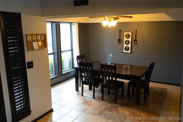 dining area with ceiling fan, visible vents, and baseboards