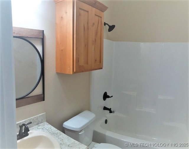 full bathroom featuring tub / shower combination, vanity, and toilet