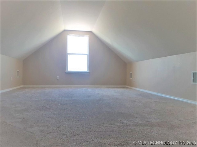 bonus room with lofted ceiling, carpet, and baseboards