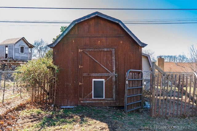 view of shed featuring fence