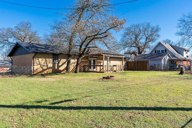 view of yard featuring a fire pit, fence, and a pergola