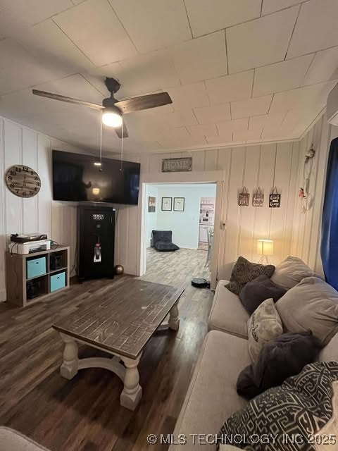 living room with ceiling fan and wood finished floors