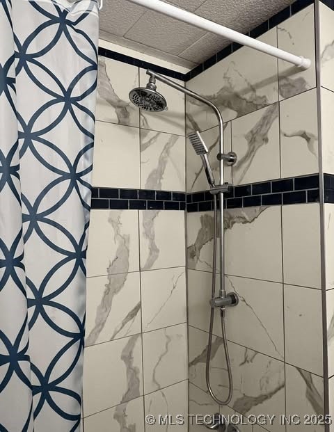 interior details featuring a tile shower