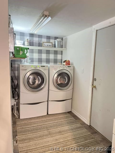 clothes washing area featuring laundry area, wood finished floors, and independent washer and dryer