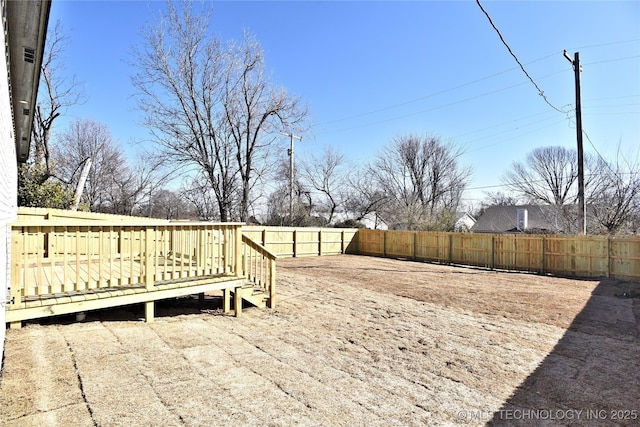 view of yard with a fenced backyard and a deck