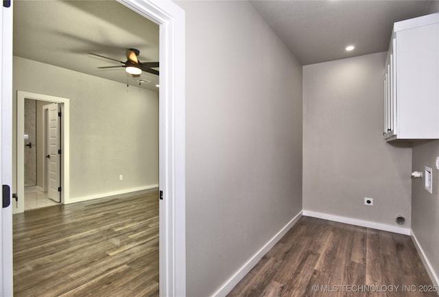 laundry room with baseboards, dark wood-style flooring, cabinet space, and hookup for an electric dryer