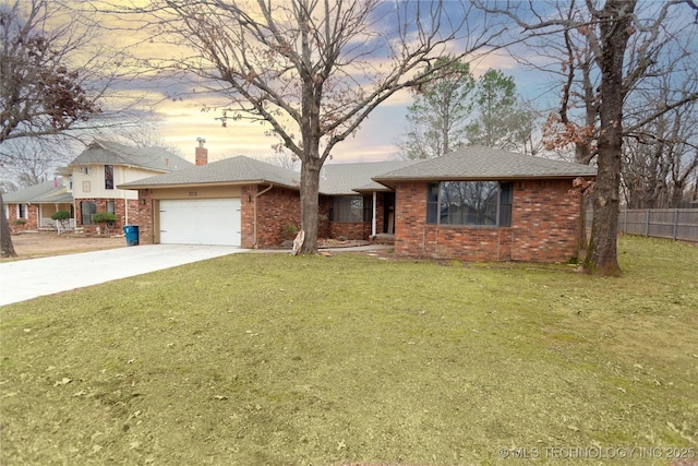 single story home featuring driveway, brick siding, a lawn, and fence