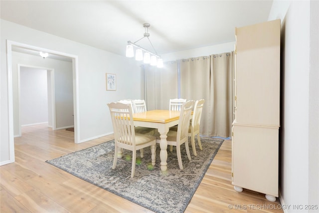 dining room with light wood-style flooring and baseboards