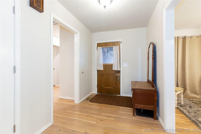 entrance foyer featuring light wood finished floors and baseboards