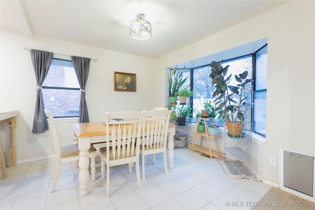 dining area with light tile patterned floors and baseboards