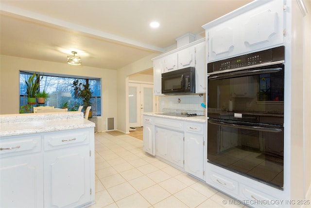 kitchen featuring light tile patterned floors, visible vents, decorative backsplash, white cabinets, and black appliances