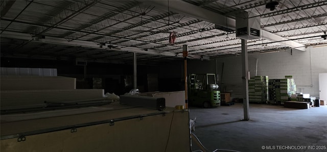 garage with concrete block wall and a garage door opener