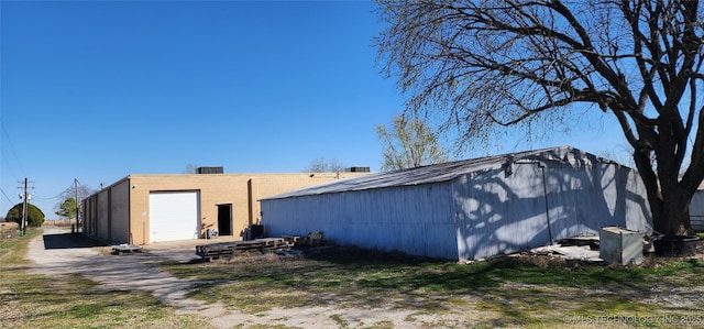 back of house featuring an outbuilding and a pole building