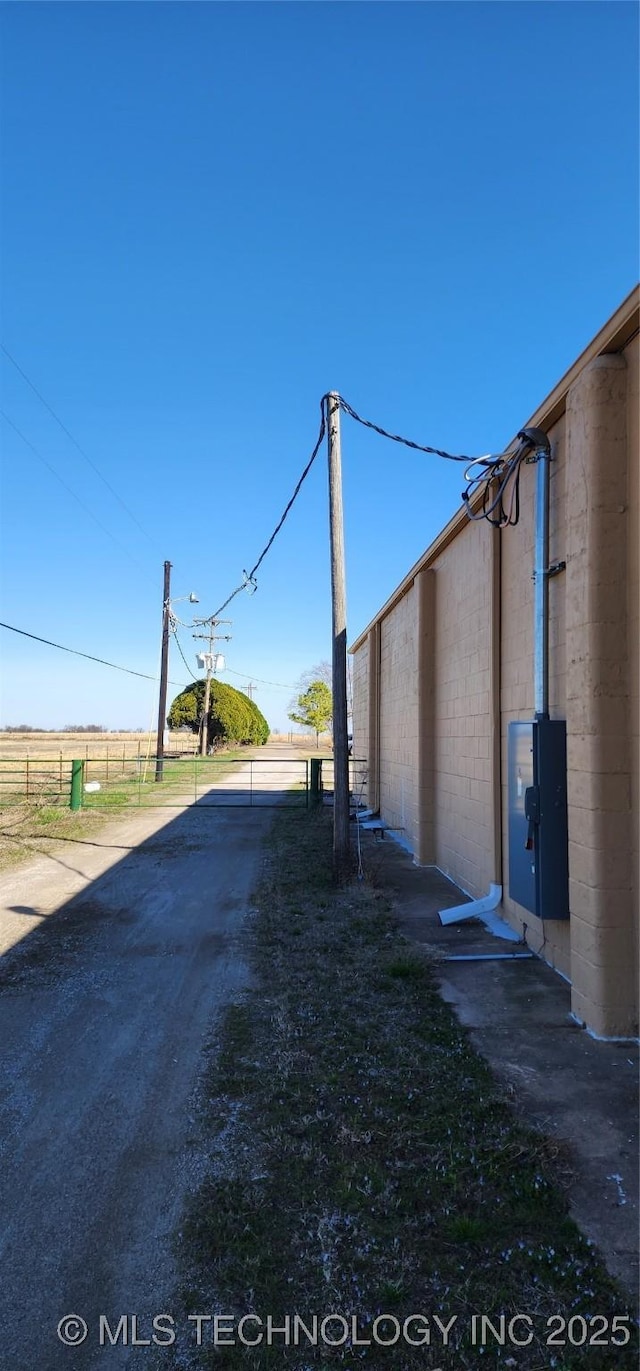 view of street featuring aphalt driveway and a gated entry