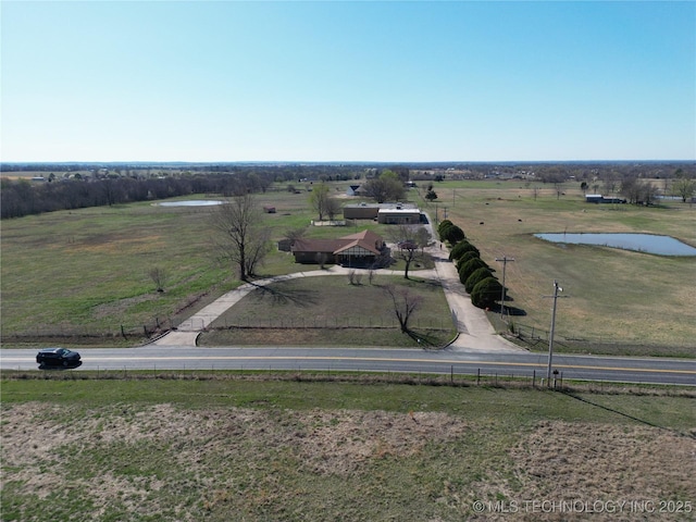 drone / aerial view featuring a rural view and a water view