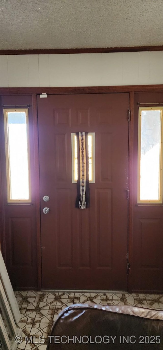 entryway featuring a textured ceiling