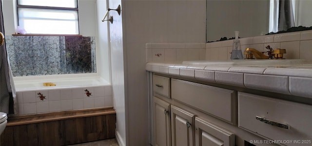 bathroom with a relaxing tiled tub, tasteful backsplash, toilet, and vanity