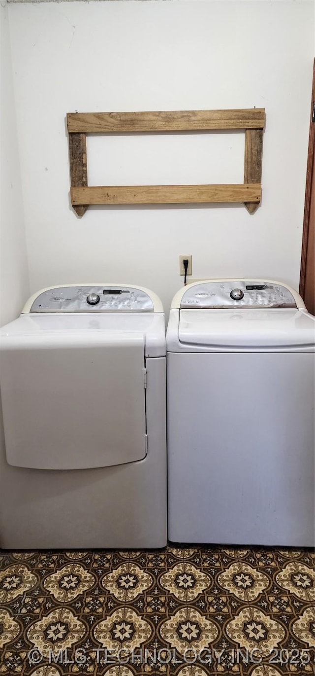 washroom with laundry area, washing machine and dryer, and tile patterned floors