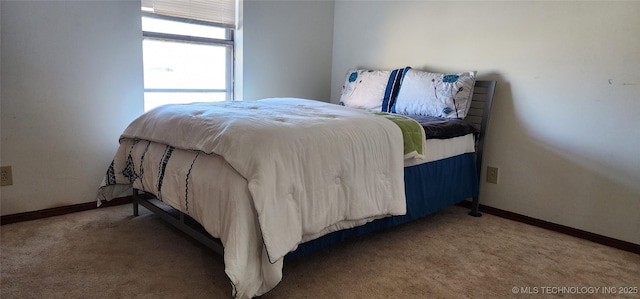 bedroom with carpet flooring and baseboards