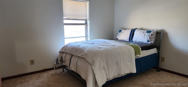 carpeted bedroom featuring baseboards