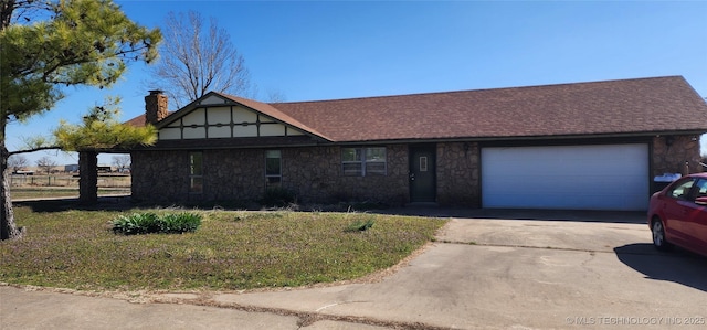 english style home featuring an attached garage, driveway, a chimney, and roof with shingles