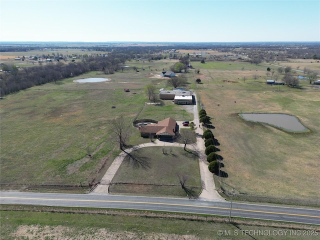 birds eye view of property featuring a rural view