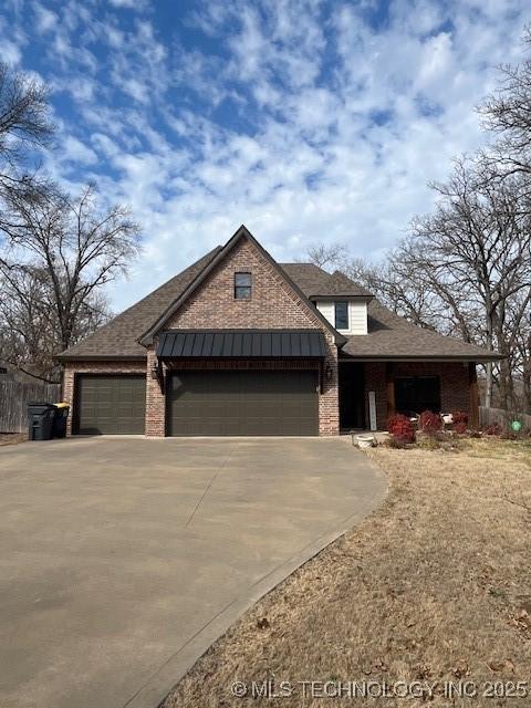 view of front facade featuring concrete driveway, a garage, and brick siding