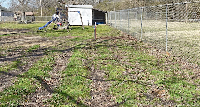 view of yard featuring a playground and fence