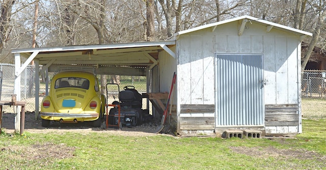 view of outdoor structure with an outbuilding and fence