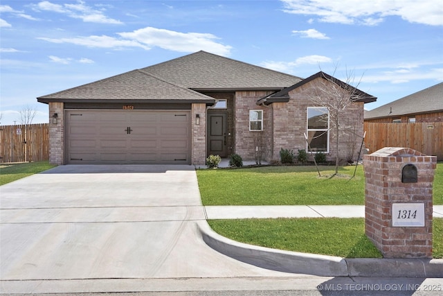 view of front of property with concrete driveway, brick siding, a front yard, and fence