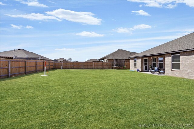 view of yard with a fenced backyard and a patio