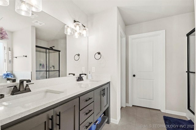 full bathroom featuring tile patterned flooring, a shower stall, visible vents, and a sink