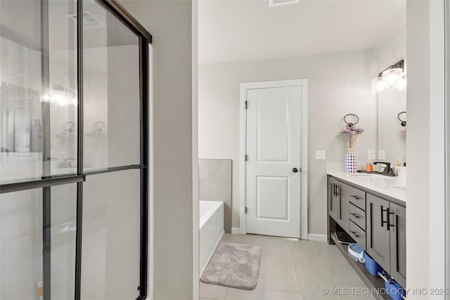 full bathroom featuring a bath, a stall shower, tile patterned flooring, and vanity