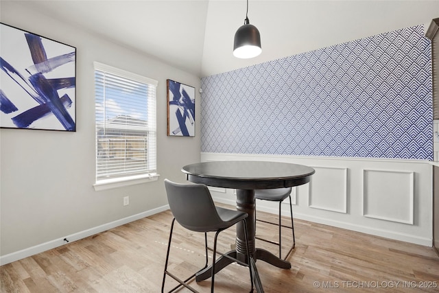 dining area with light wood-type flooring and baseboards