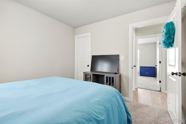 bedroom with carpet floors and baseboards