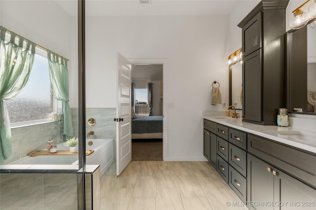 full bathroom featuring connected bathroom, double vanity, a sink, and a bath