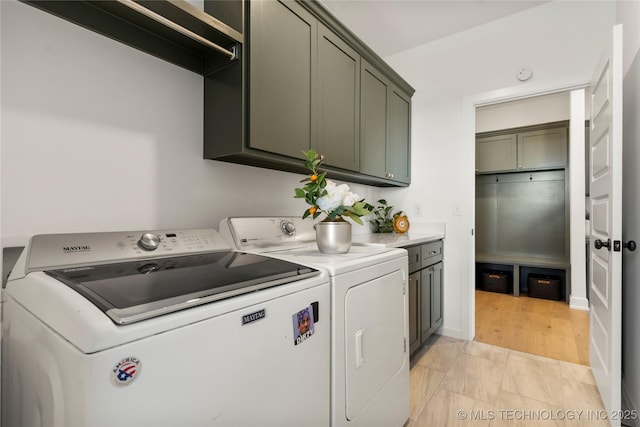 laundry room featuring washing machine and dryer and cabinet space
