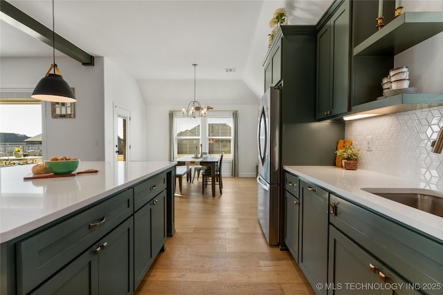 kitchen with open shelves, light countertops, backsplash, green cabinets, and light wood-style floors