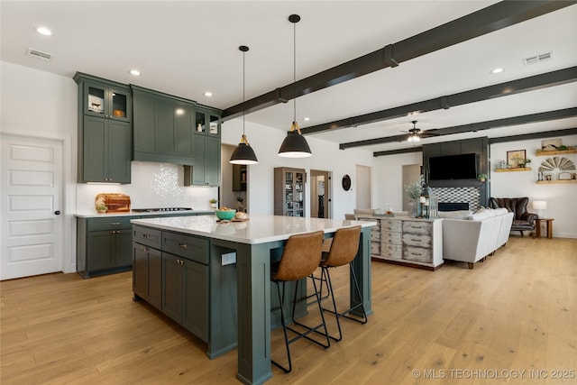 kitchen with green cabinetry, visible vents, and light wood-type flooring