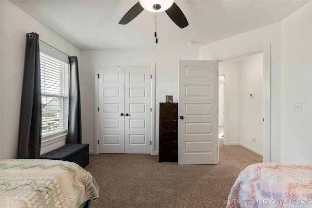 bedroom featuring carpet floors, a closet, a ceiling fan, and baseboards