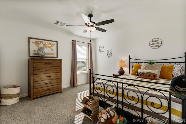 carpeted bedroom with a ceiling fan, baseboards, and visible vents