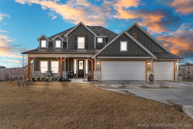 craftsman-style home with a garage, concrete driveway, fence, a porch, and board and batten siding