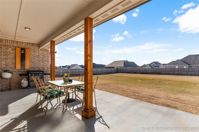 view of patio / terrace featuring a fenced backyard, area for grilling, and outdoor dining space