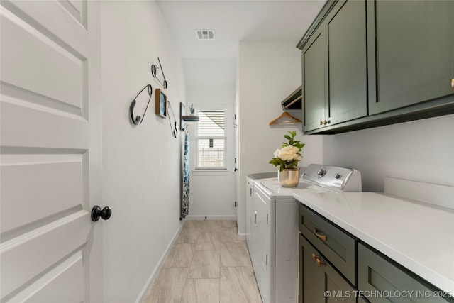 laundry room with separate washer and dryer, cabinet space, baseboards, and visible vents