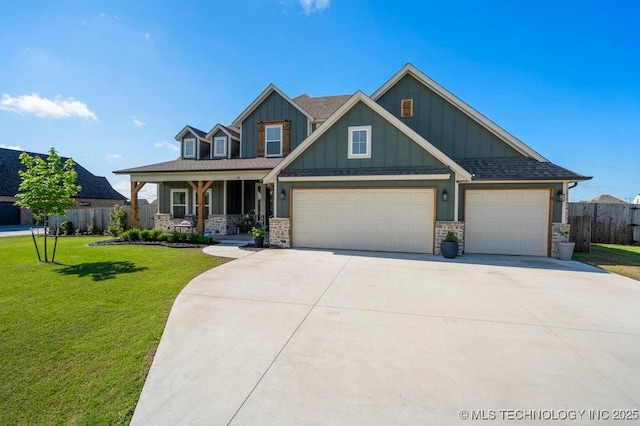 craftsman-style home with a garage, board and batten siding, fence, and covered porch